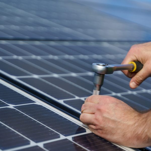 man worker installing solar photovoltaic panels