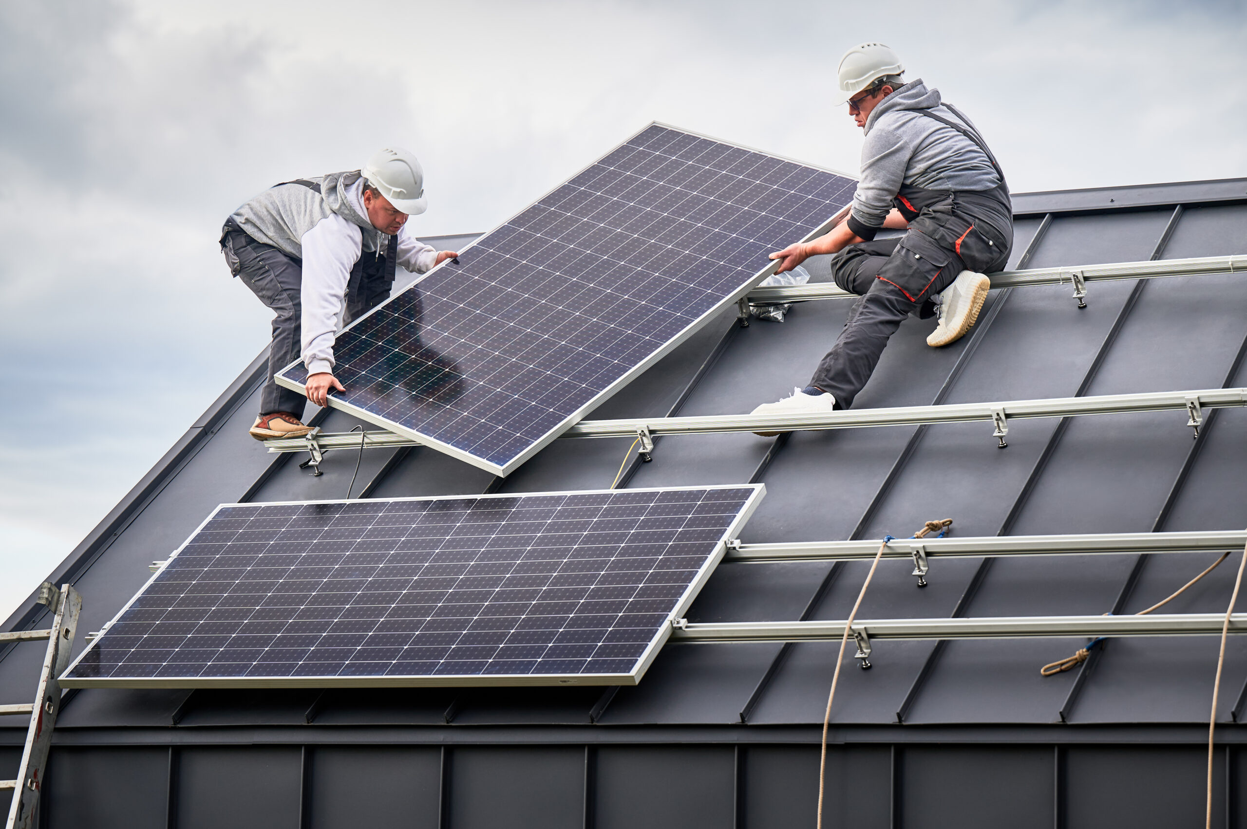 Workers building solar panel system