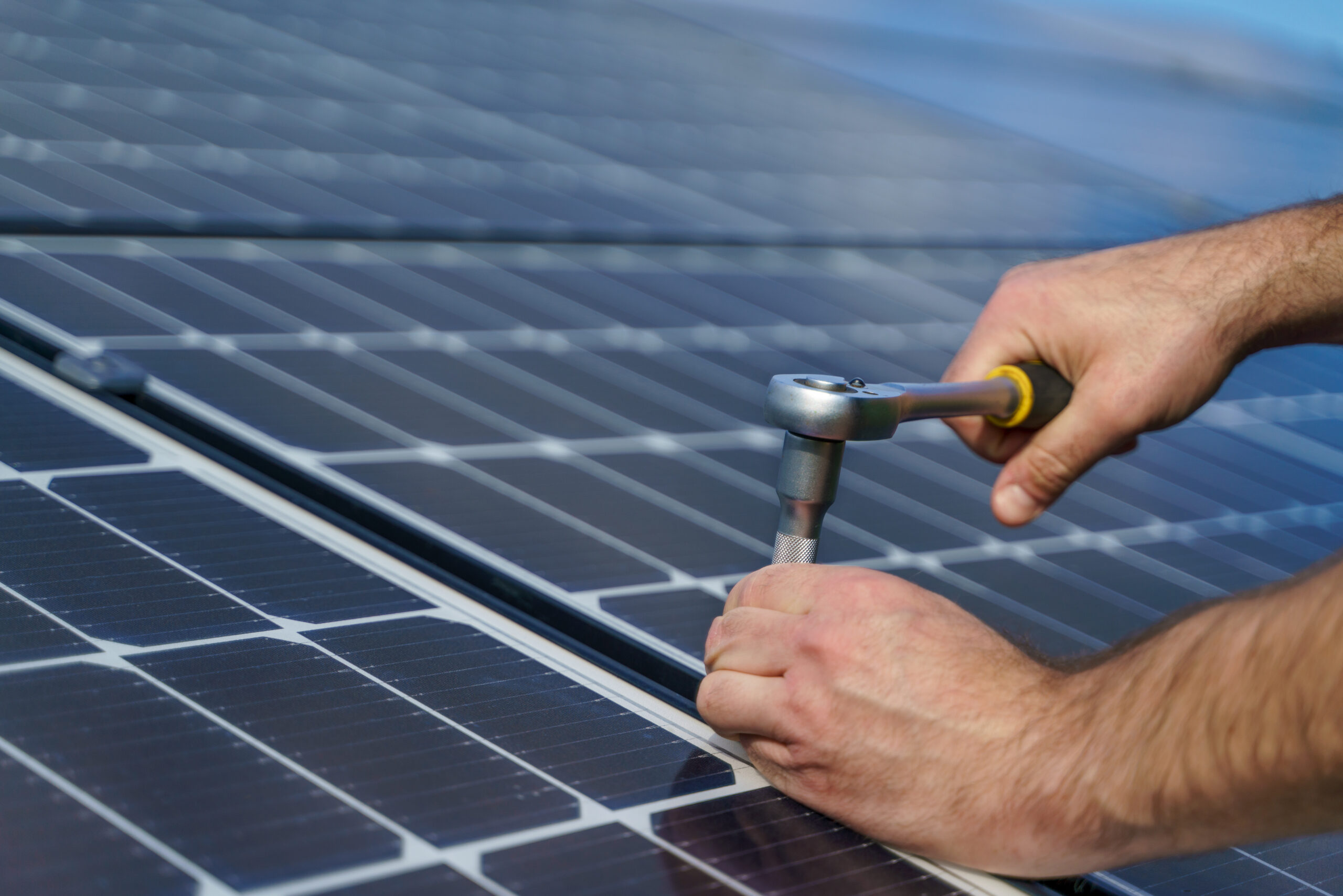 man worker installing solar photovoltaic panels